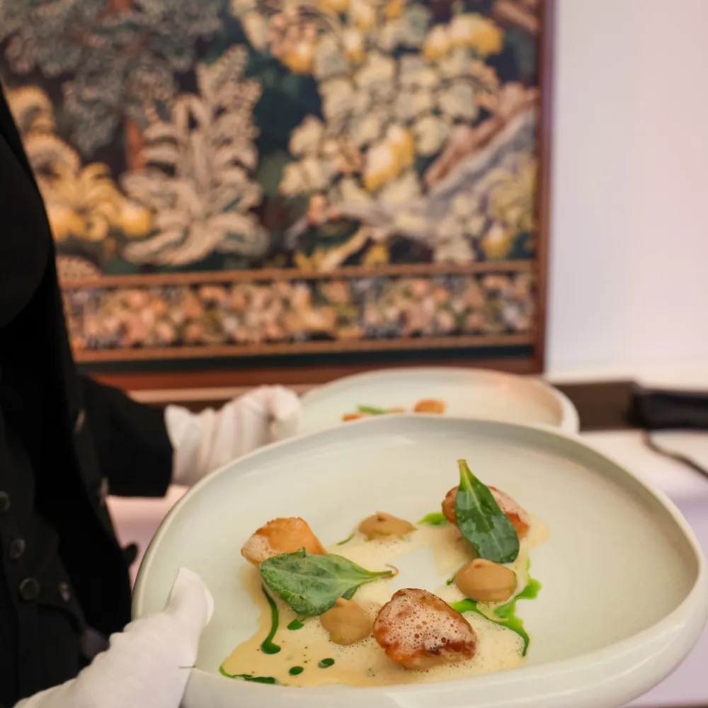 Waitress holding a plate of scallops