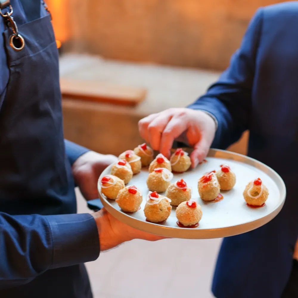 **Image Name:** Canapés at the Cutty Sark  **Alt Text:** Canapés served during a drinks reception beneath the Cutty Sark, offering guests a selection of elegant bite-sized dishes.