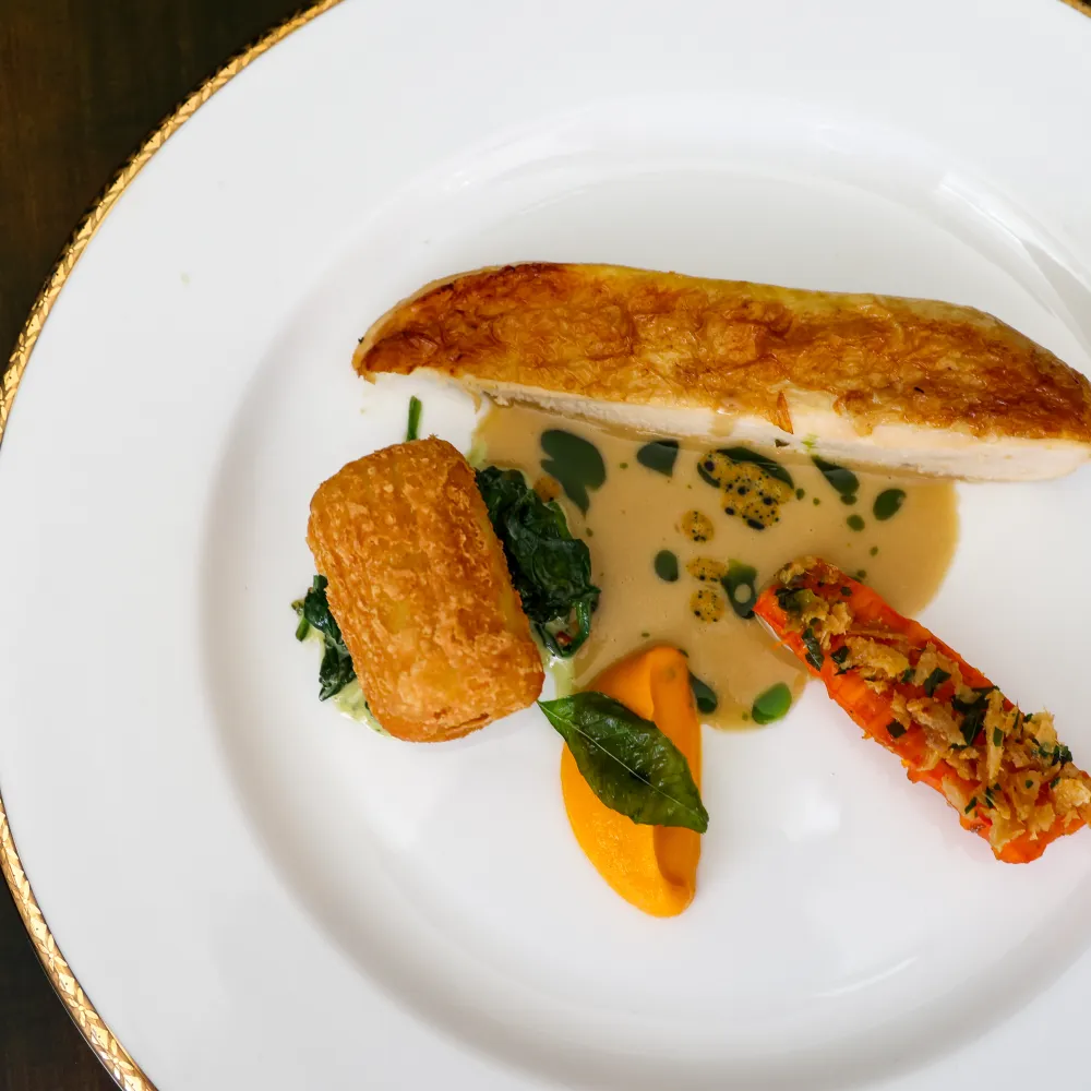 FOSSE MEADOWS FARM CHICKEN with glazed heritage carrot, confit leg dauphine, kale, poulet blanc from the new autumn winter 2026 menu