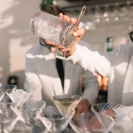 Staff cocktail bartender pour creative summer martini