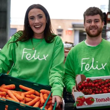 People holding boxes of vegetables in Felix green tops