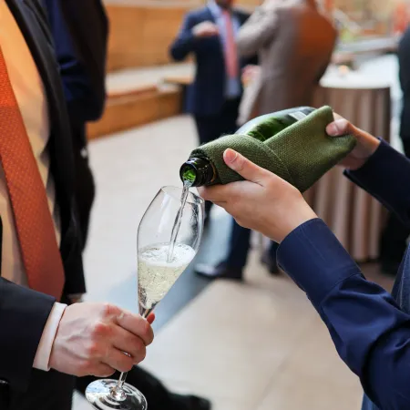 Champagne being served to guests during a drinks reception beneath the Cutty Sark