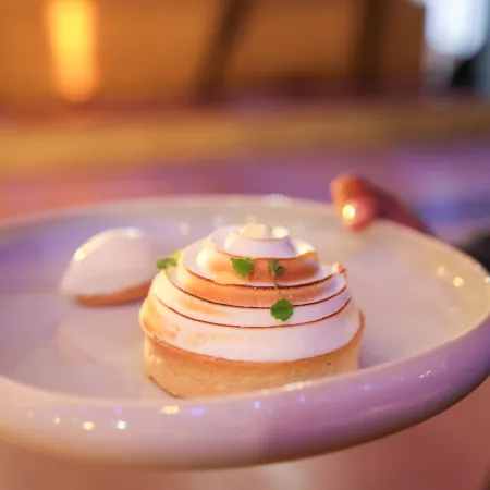 Dessert of the three-course dinner which is citrus meringue tartlet