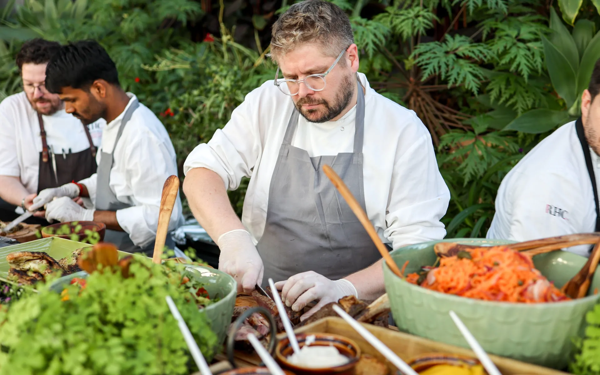 Chef and other staff preparing dishes at Sky Garden summer event food station 