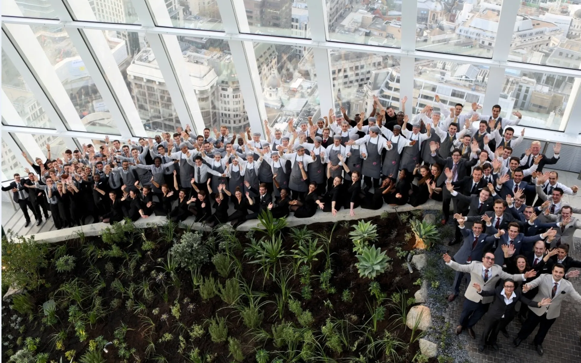 Staff gathered together in Sky Garden waving to the camera