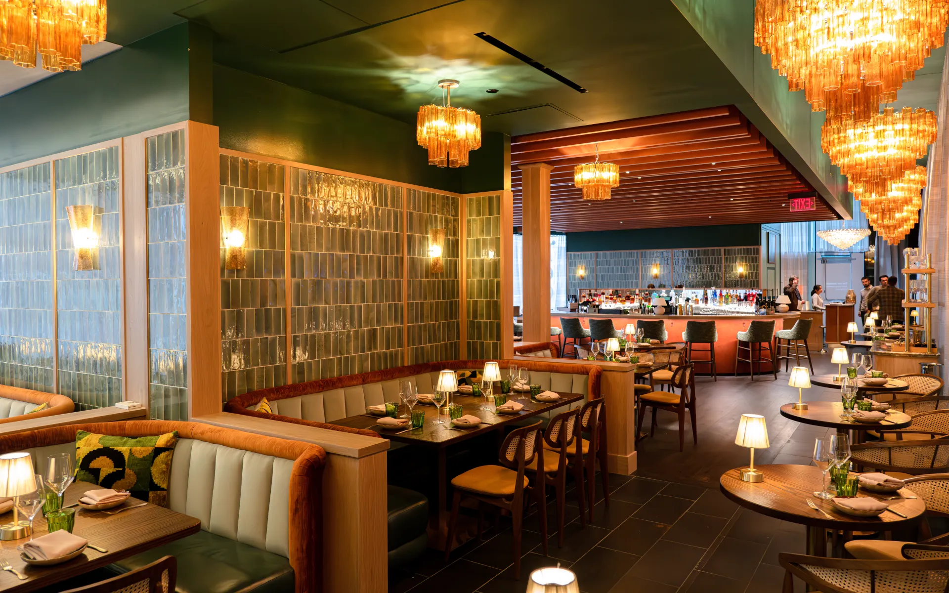 Interior of Leo restaurant, featuring dining tables, banquette seating and the central bar