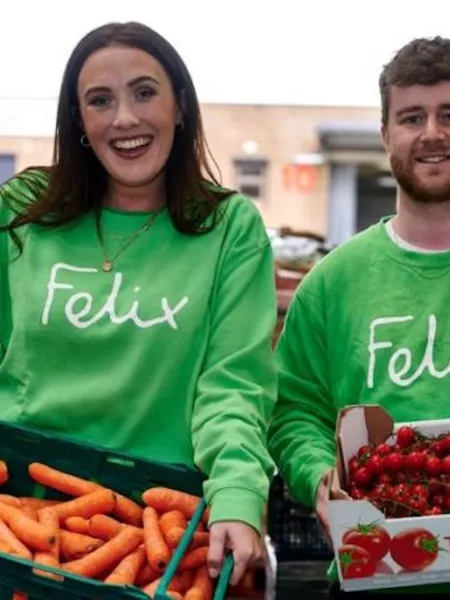 People holding boxes of vegetables in Felix green tops