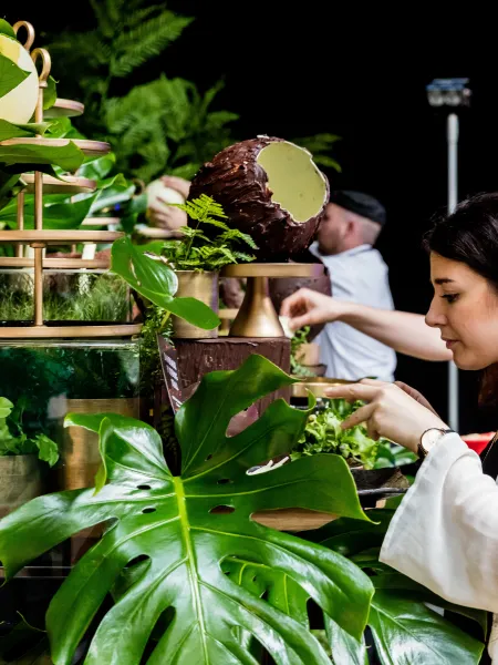 Creative team setting up a plant stall display at an event