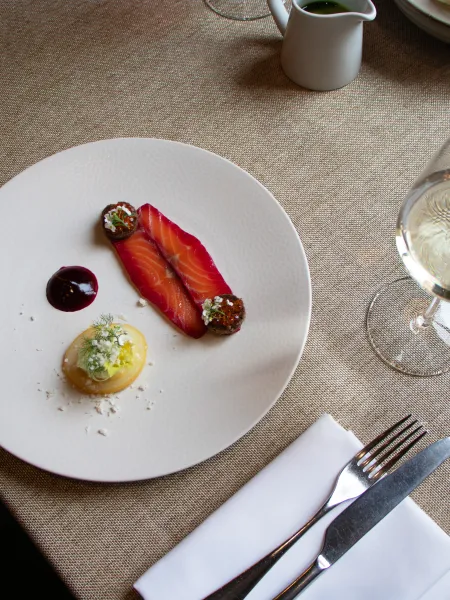 Seasonal salmon starter served with a glass of white wine at The Elgar Room