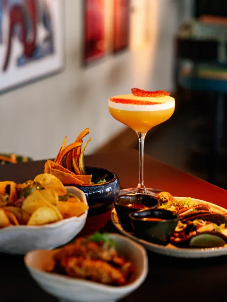 ignature cocktail served alongside tacos and sharing plates at AirBar13.