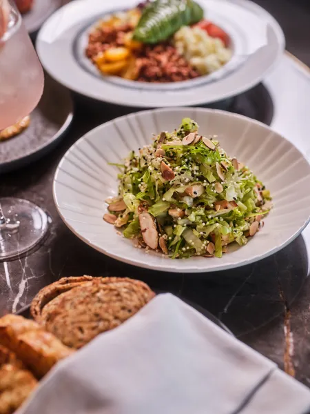 Fresh green salad with grilled chicken, sliced almonds and seeds served at Skywalker Grill.