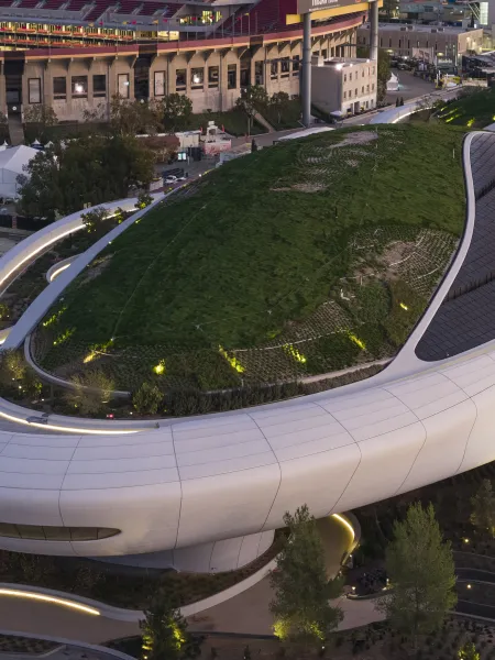 Aerial view of the Lucas Museum of Narrative Art, showing its curved architecture and landscaped green roof.