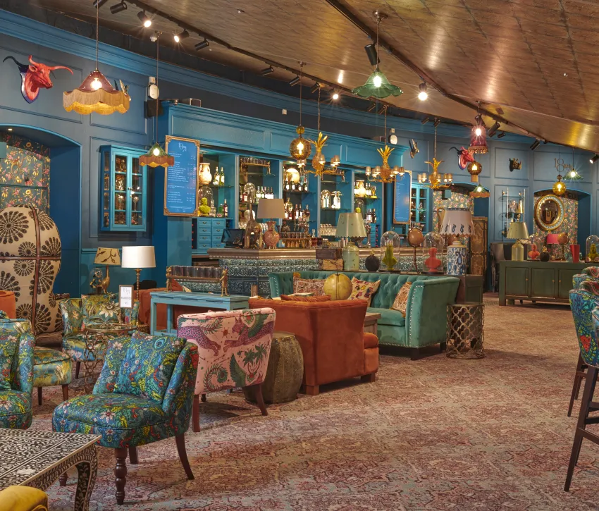 **Colourful interior of 1871 Bar at the Royal Albert Hall, featuring patterned seating and eclectic décor**