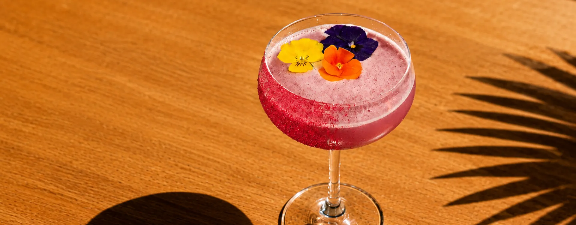 Pride Cocktail which is pink with rainbow flowers