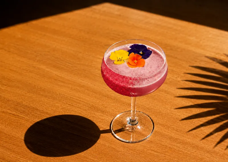 Pride Cocktail which is pink with rainbow flowers