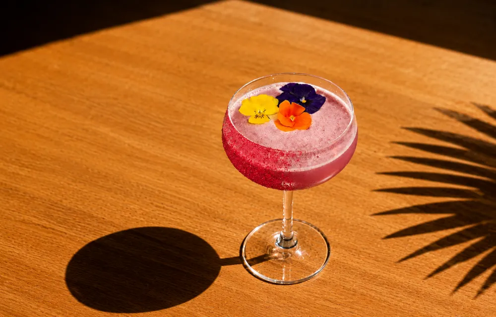 Pride Cocktail which is pink with rainbow flowers