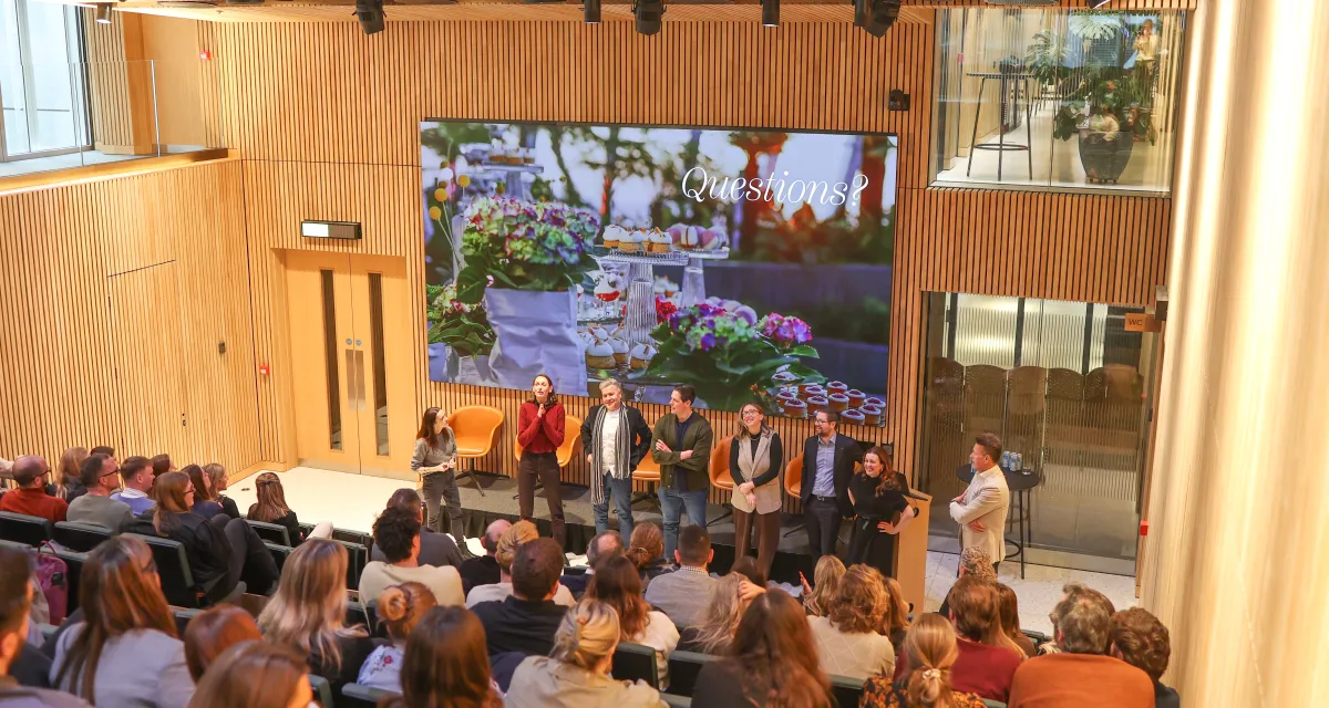 Team presenting to a hall of people at 8 Bishopsgate